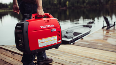 A person carries a generator on a dock.